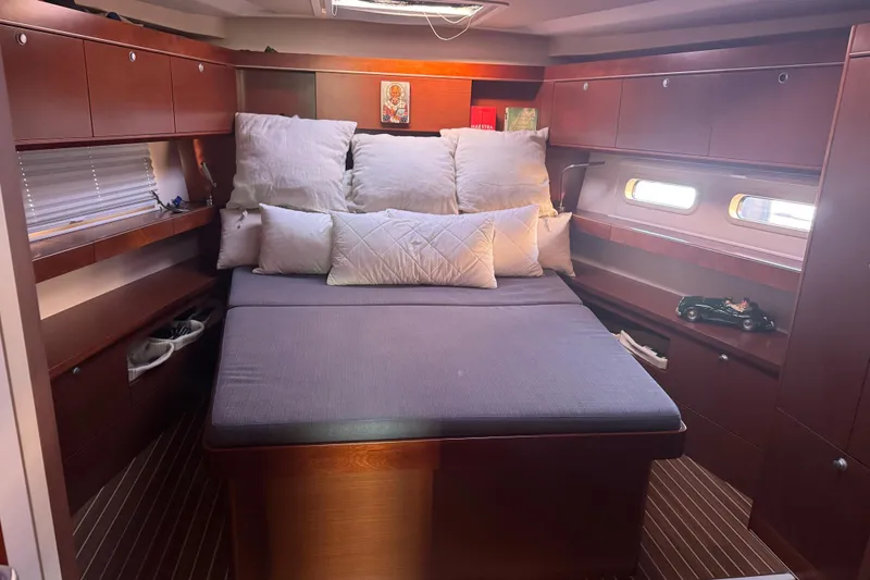  Yacht Photos Pics Luxurious cabin interior of 2013 Hanse 575 yacht with cozy bedding and wooden finish.