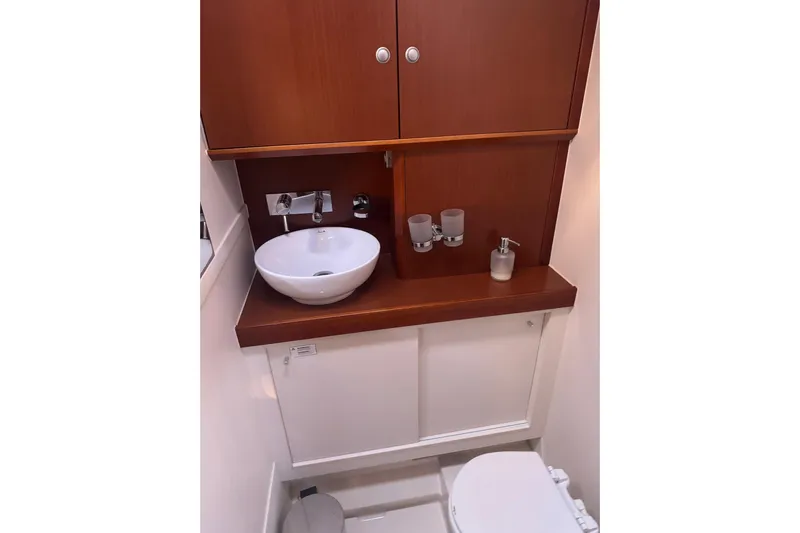 Yacht Photos Pics Luxurious bathroom in 2013 Hanse 575 yacht with modern sink and wooden cabinetry.