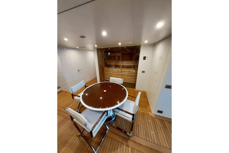  Yacht Photos Pics Luxurious Benetti B.NOW 2022 yacht interior with elegant round table and chairs.