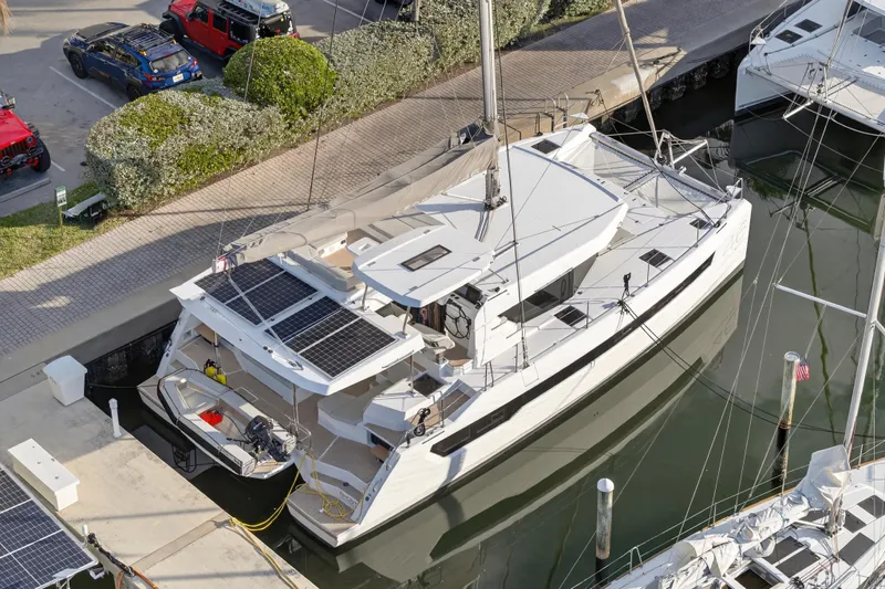  Yacht Photos Pics 2025 Leopard 46 catamaran docked, featuring solar panels and modern design.