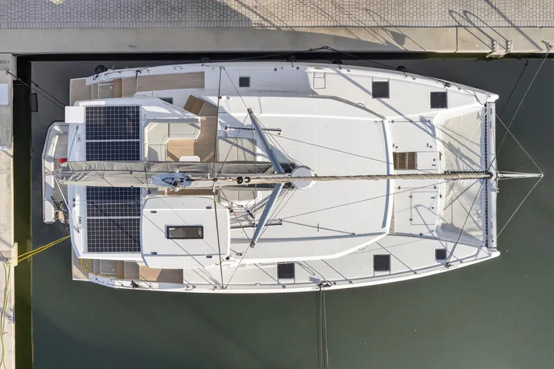  Yacht Photos Pics Aerial view of 2025 Leopard 46 catamaran docked, featuring solar panels and spacious deck.