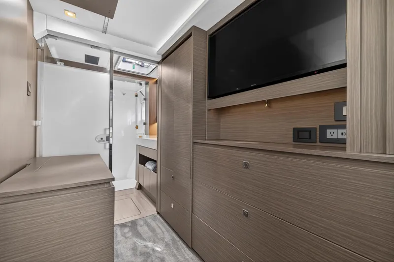  Yacht Photos Pics Luxurious interior of 2025 Leopard 46 yacht featuring modern cabinetry and a flat-screen TV.