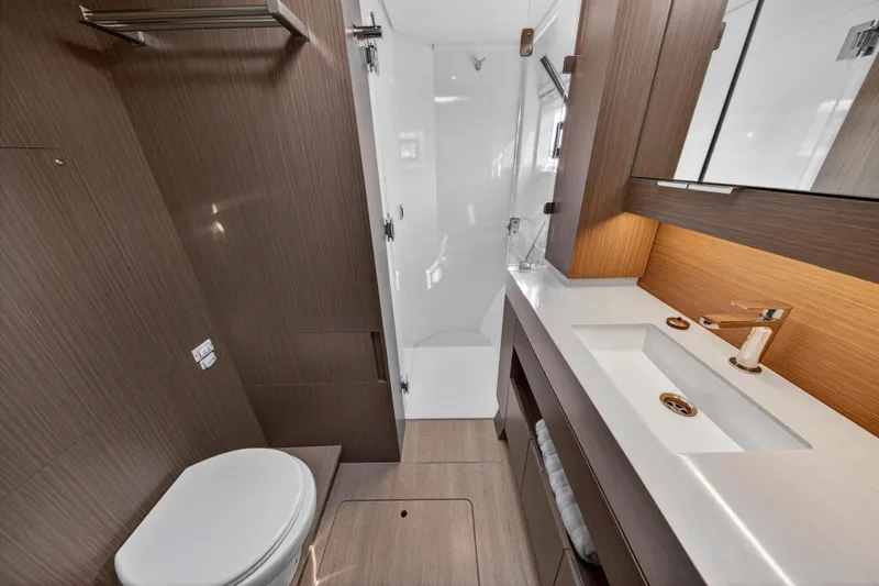  Yacht Photos Pics Modern bathroom in 2025 Leopard 46 yacht with sleek wood finishes and elegant fixtures.