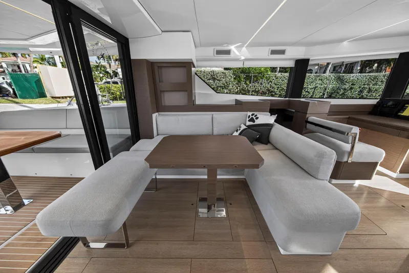  Yacht Photos Pics Modern interior of 2025 Leopard 46 yacht with sleek seating and wooden table.