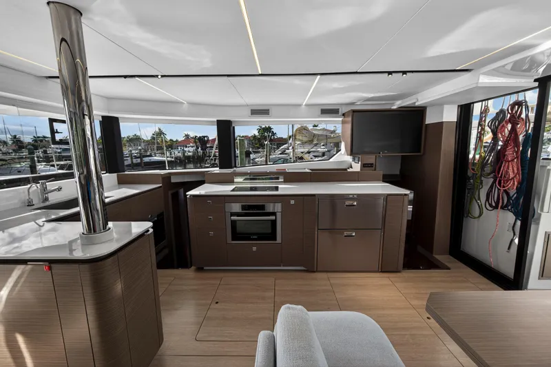  Yacht Photos Pics Luxurious interior of 2025 Leopard 46 yacht featuring modern kitchen and panoramic windows.