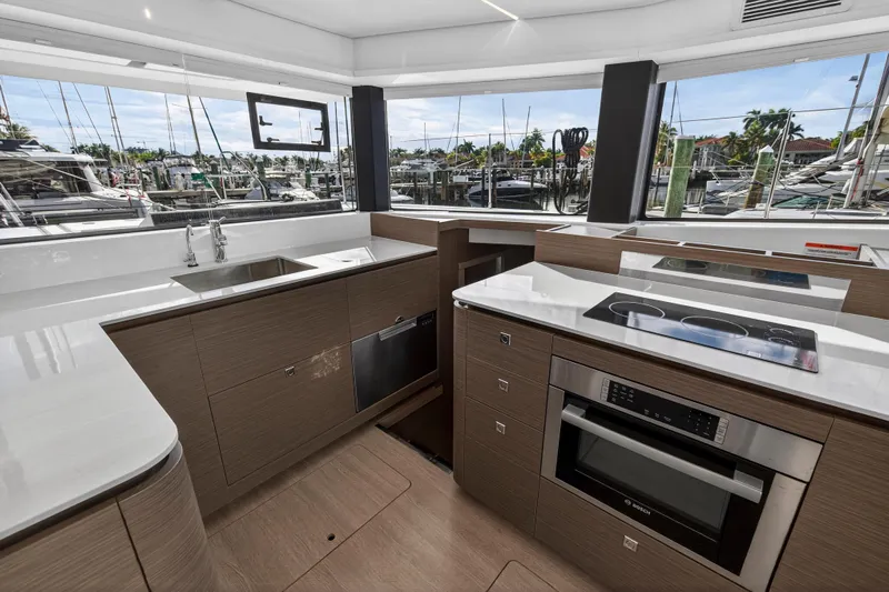  Yacht Photos Pics Modern kitchen interior on Leopard 46 yacht, 2025 model, featuring sleek appliances and marina view.