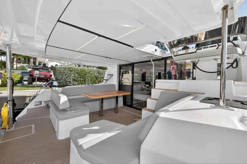  Yacht Photos Pics Luxurious 2025 Leopard 46 yacht interior with modern seating and dining area.