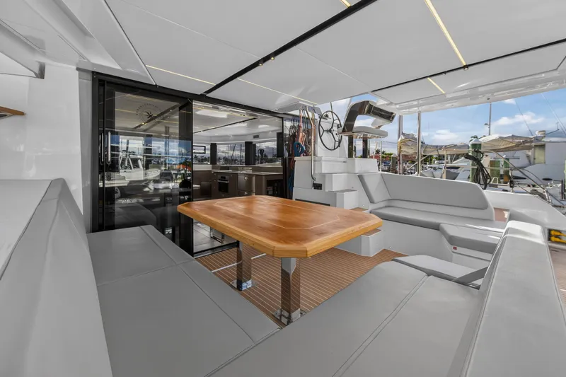 Yacht Photos Pics Luxurious 2025 Leopard 46 yacht interior with modern seating and wooden table.