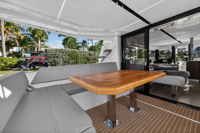  Yacht Photos Pics Luxurious Leopard 46 yacht interior with sleek seating and wooden table, 2025 model.