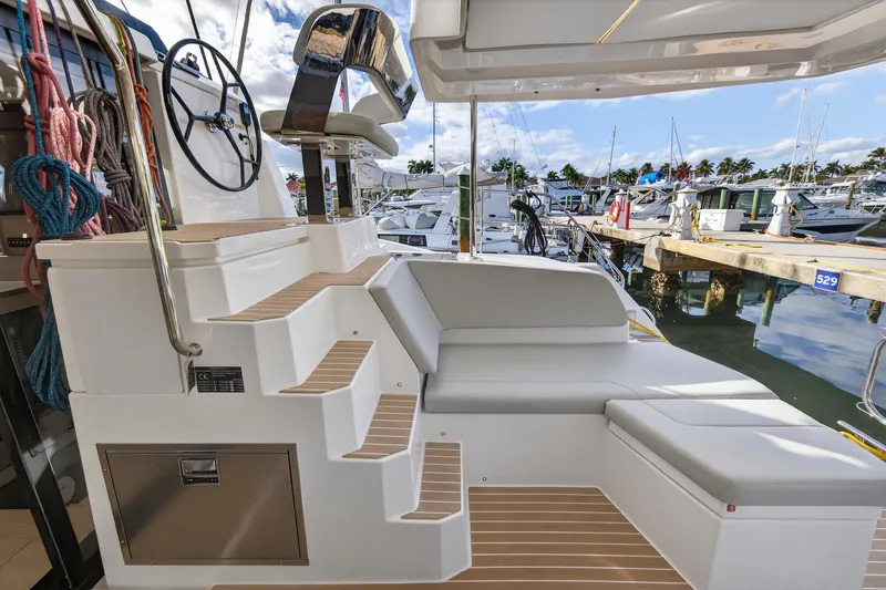  Yacht Photos Pics Luxurious Leopard 46 yacht interior, showcasing helm and seating area, docked at marina.