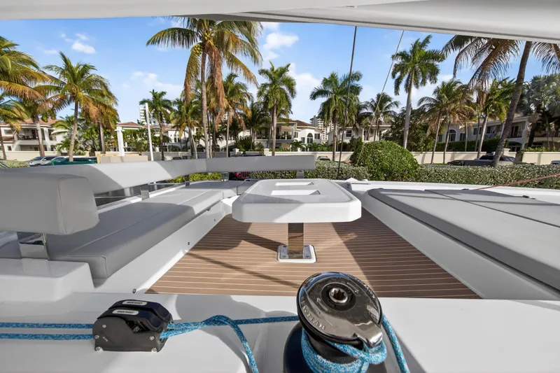  Yacht Photos Pics Luxurious Leopard 46 yacht deck with seating, table, and palm trees in the background, 2025 model.