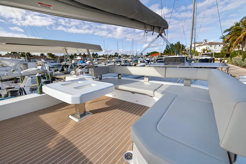  Yacht Photos Pics Luxurious 2025 Leopard 46 yacht with spacious deck seating in a marina setting.