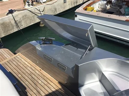 2010 Pershing 64' yacht with open storage compartment at marina.