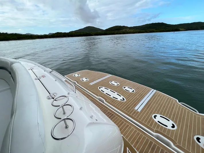  Yacht Photos Pics Sea Ray 48 Sundancer 2006 on calm water with cloudy sky.
