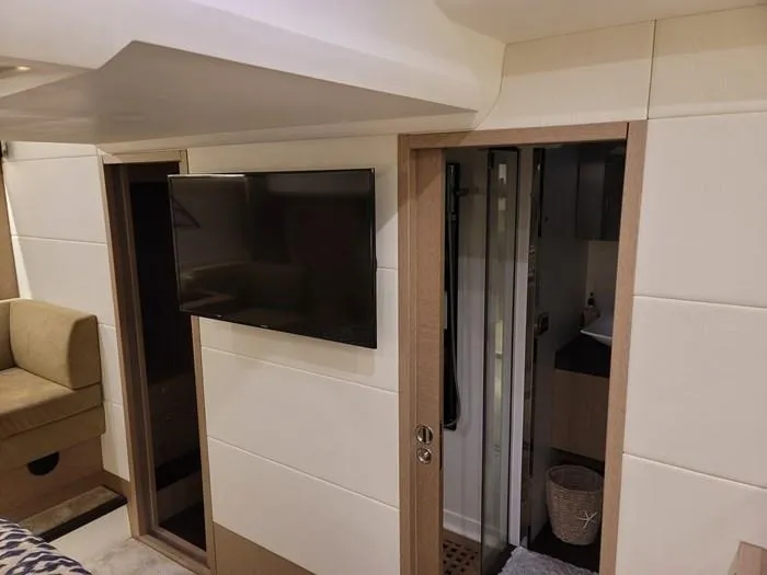  Yacht Photos Pics Interior of a 2016 Prestige 560 yacht with TV and bathroom.