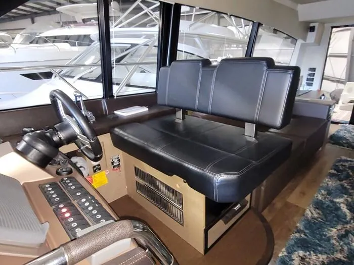  Yacht Photos Pics Interior of a 2016 Prestige 560 yacht with helm and seating area.