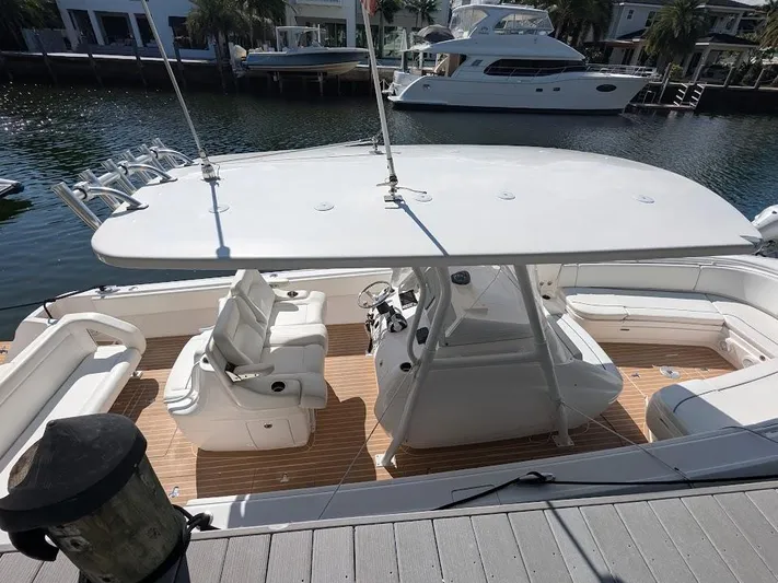  Yacht Photos Pics Intrepid 327 Center Console boat docked, featuring spacious seating and modern design, 2017 model.