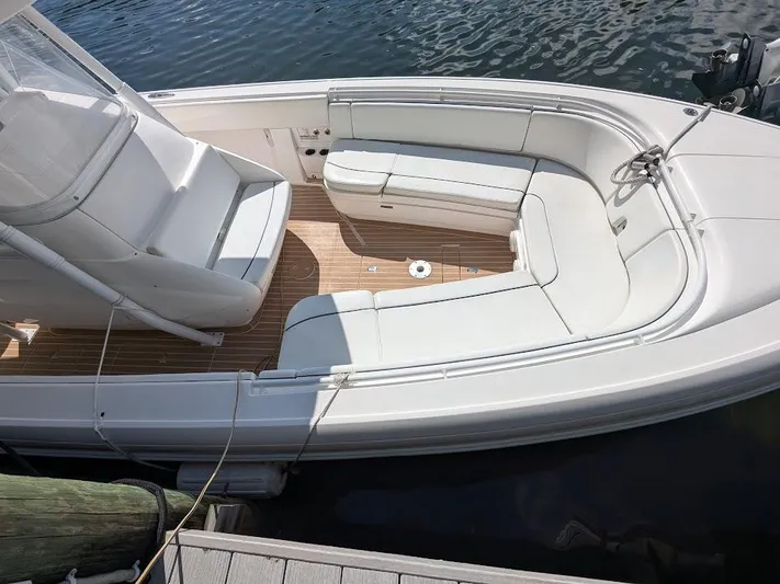  Yacht Photos Pics Intrepid 327 Center Console 2019, white seating, teak deck, docked on water.