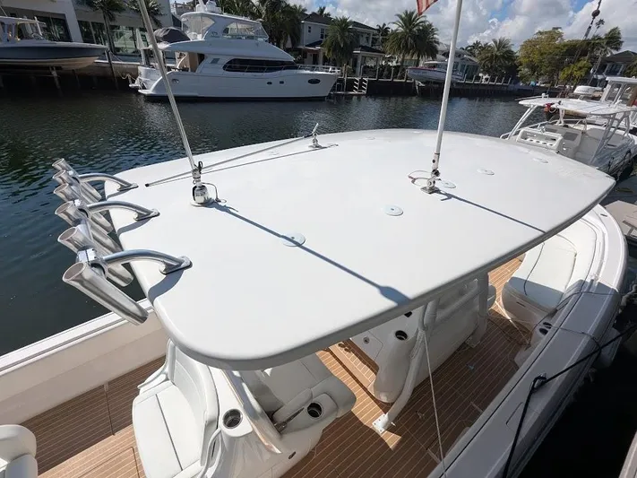  Yacht Photos Pics Intrepid 327 Center Console boat docked, showcasing spacious deck and seating, 2017 model.