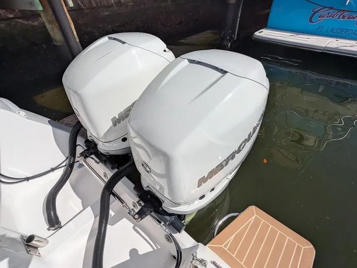  Yacht Photos Pics Twin Mercury outboard motors on Intrepid 327 Center Console boat, docked in water.