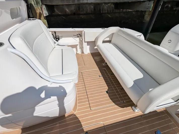  Yacht Photos Pics White seating area on 2017 Intrepid 327 Center Console boat with wooden deck.