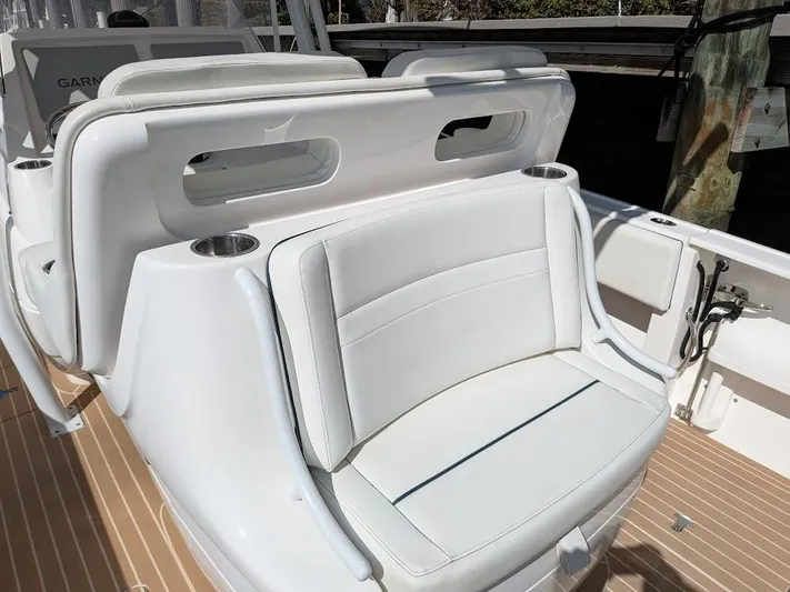  Yacht Photos Pics White seating on 2017 Intrepid 327 Center Console boat, featuring cup holders and sleek design.
