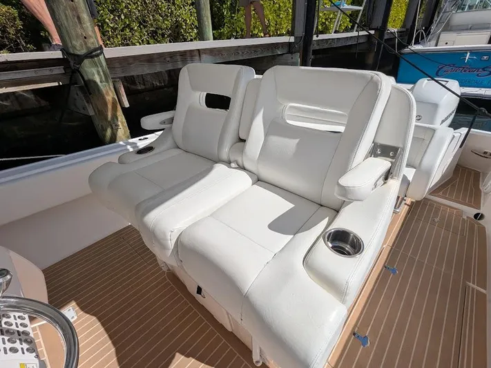  Yacht Photos Pics White leather seats on 2017 Intrepid 327 Center Console boat, teak flooring, cup holders.