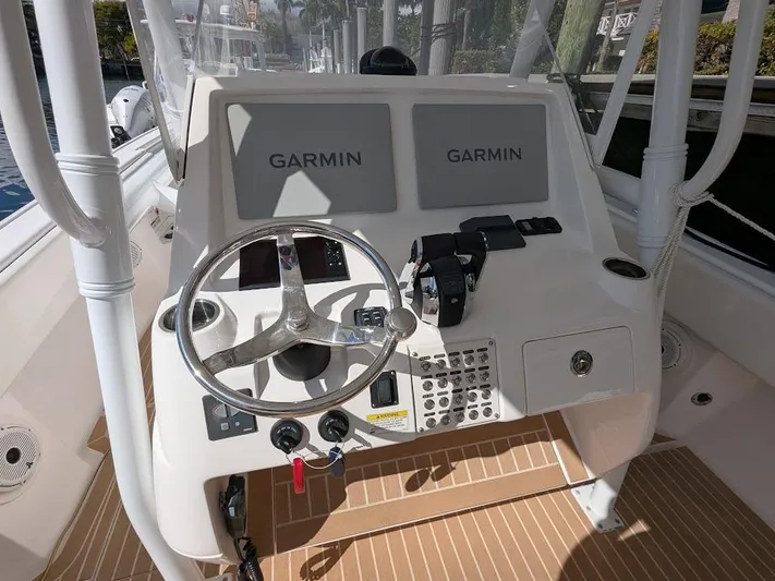  Yacht Photos Pics Center console of 2017 Intrepid 327 boat with Garmin displays and steering wheel.