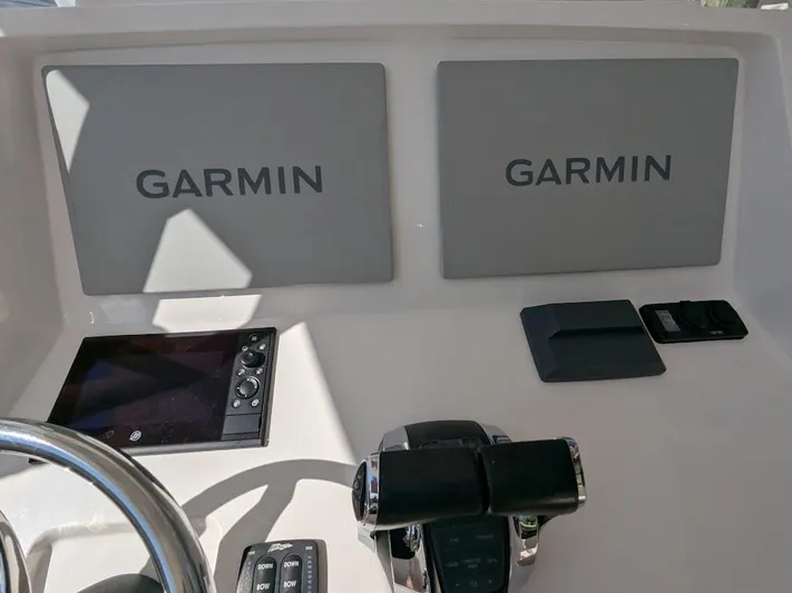  Yacht Photos Pics Control panel of 2017 Intrepid 327 Center Console with Garmin displays and throttle controls.