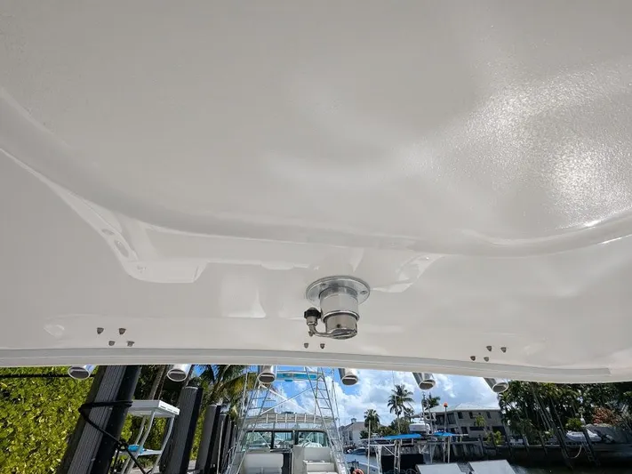  Yacht Photos Pics Intrepid 327 Center Console boat ceiling with lighting, docked near waterfront homes.