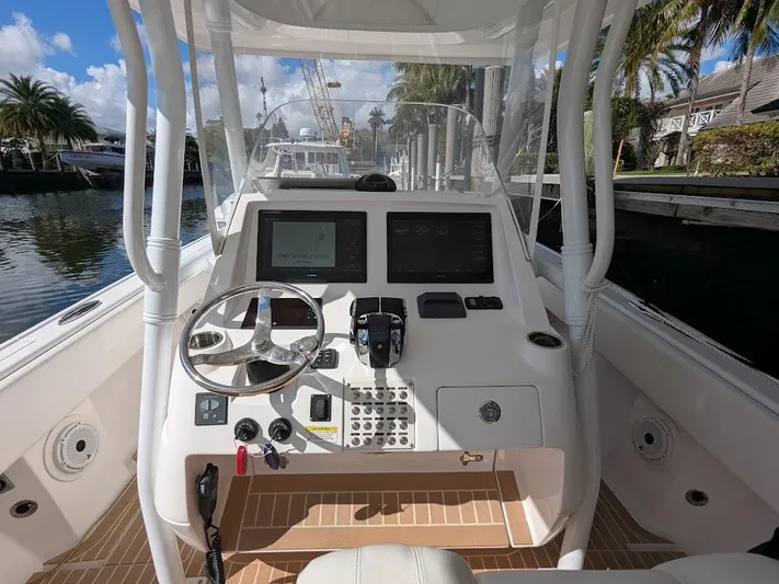  Yacht Photos Pics Center console of 2017 Intrepid 327 boat with dual screens and steering wheel.