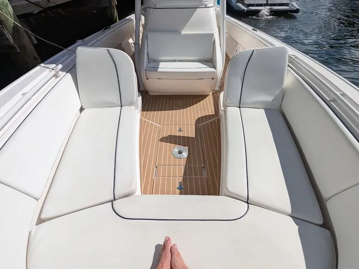  Yacht Photos Pics Intrepid 327 Center Console 2017 boat interior with white seating and wooden deck.