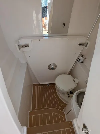  Yacht Photos Pics Intrepid 327 Center Console 2019 boat bathroom interior with toilet and sink, 2017 model.