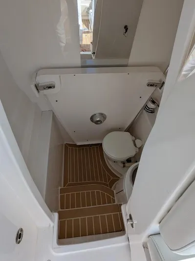  Yacht Photos Pics Interior of 2017 Intrepid 327 Center Console boat with compact marine toilet.
