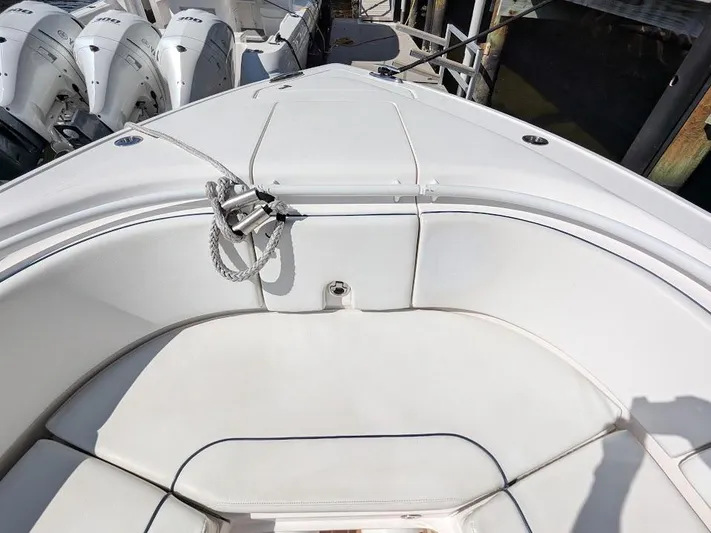  Yacht Photos Pics Bow seating area of a 2017 Intrepid 327 Center Console boat with white upholstery.