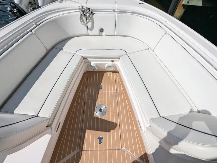  Yacht Photos Pics Intrepid 327 Center Console 2019 boat interior with white seating and teak flooring.