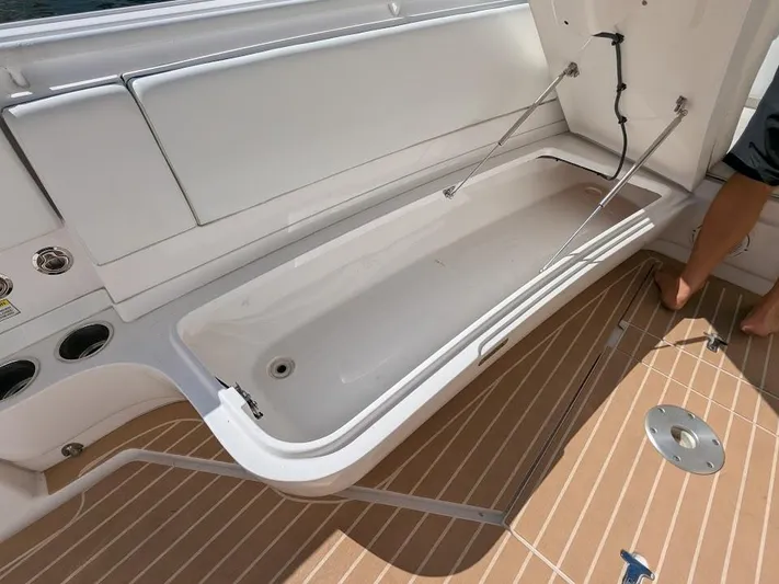  Yacht Photos Pics Open storage compartment on 2017 Intrepid 327 Center Console boat with teak flooring.
