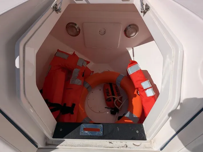  Yacht Photos Pics Storage compartment with life jackets and ring buoy on Intrepid 327 Center Console boat.