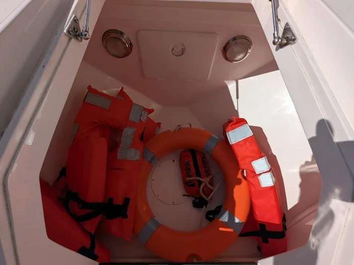  Yacht Photos Pics Storage compartment with life jackets and ring buoy on Intrepid 327 Center Console boat.