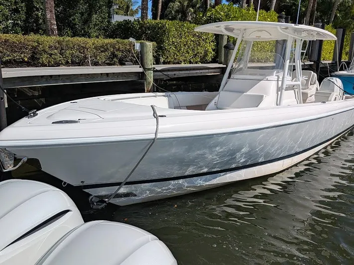  Yacht Photos Pics Intrepid 327 Center Console boat, 2017 model, docked in sunny marina.