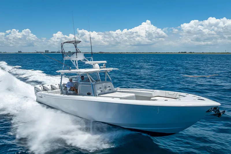 Clean Trade-ins Accepted - Bring Offers Yacht Photos Pics 2021 Contender 44 CB boat cruising on open water under a clear blue sky.