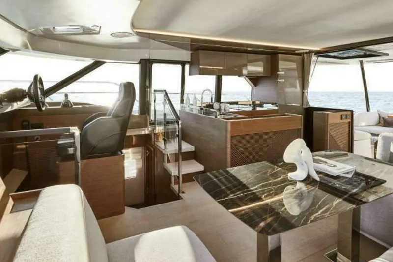 New 2026 Prestige M48 Multihull Yacht Photos Pics Luxurious interior of 2026 Prestige M48 yacht with modern kitchen and seating area.