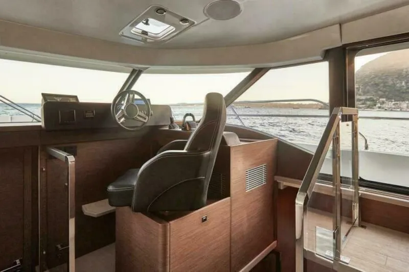 New 2026 Prestige M48 Multihull Yacht Photos Pics Interior of 2026 Prestige M48 yacht, featuring modern helm and panoramic windows.