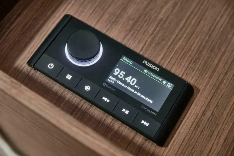 New 2026 Prestige M48 Multihull Yacht Photos Pics Prestige M48 2026 radio control panel on wooden surface, displaying 95.40 MHz frequency.