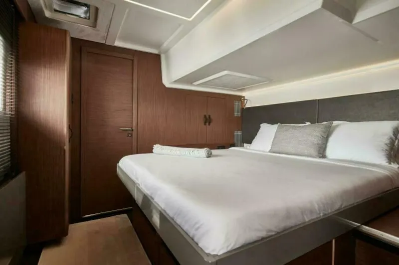 New 2026 Prestige M48 Multihull Yacht Photos Pics Luxurious cabin interior of 2026 Prestige M48 yacht with elegant bedding and wood finishes.