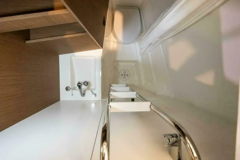 New 2026 Prestige M48 Multihull Yacht Photos Pics Modern bathroom interior in Prestige M48, 2026 model, featuring sleek fixtures and wooden accents.