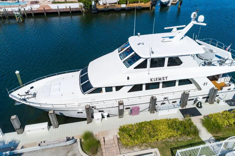 Kismet Yacht Photos Pics 2003 Hargrave Skylounge yacht docked, featuring sleek design and spacious upper deck.