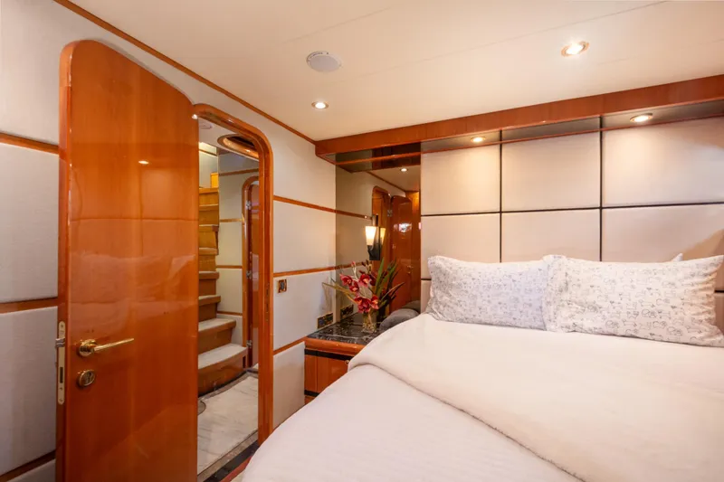 Kismet Yacht Photos Pics Luxurious bedroom interior of 2003 Hargrave Skylounge yacht with elegant wood finishes.