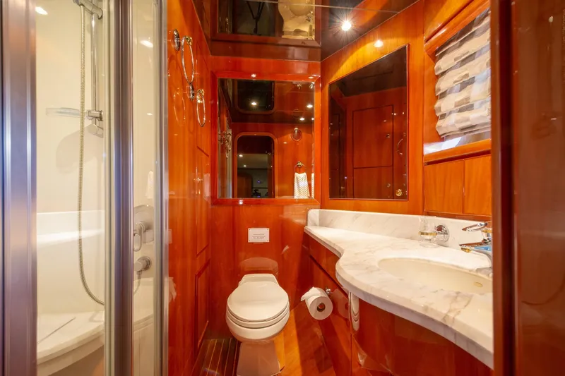 Kismet Yacht Photos Pics Luxurious bathroom in 2003 Hargrave Skylounge yacht with wood accents and marble countertop.