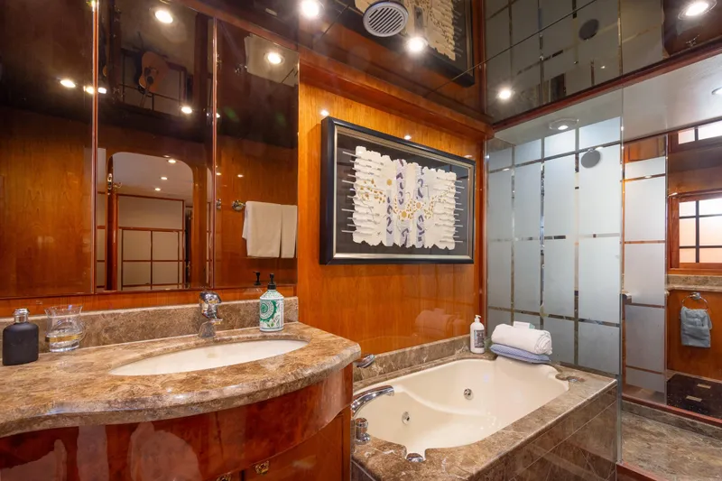 Kismet Yacht Photos Pics Luxurious bathroom in 2003 Hargrave Skylounge yacht with marble finishes and elegant decor.